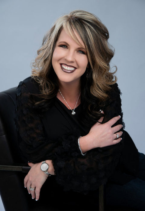 Woman smiling for her business headshot while wearing a black professional outfit with jewelry such as necklace, watch, bracelet, and ring, with makeup such as dark brown lip stick, smokey eyes, and white french tip nails, Moreland Photography, Atlanta headshot photography, business headshot, professional headshot, atlanta photographer, business headshot portrait, makeup, hair, jewelry, dark lipstick, french tip nails, bracelet, rings